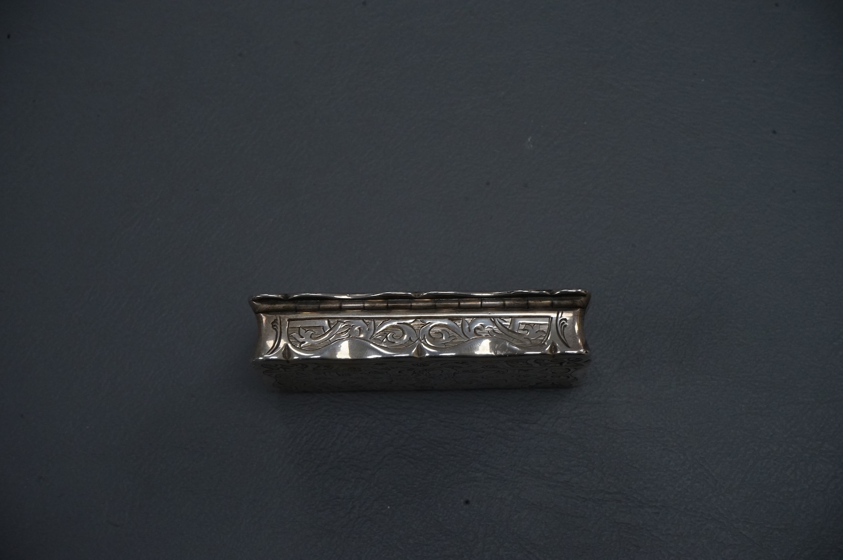 A Victorian engraved silver shaped rectangular snuff box, by George Unite, Birmingham, 1867, 7cm.